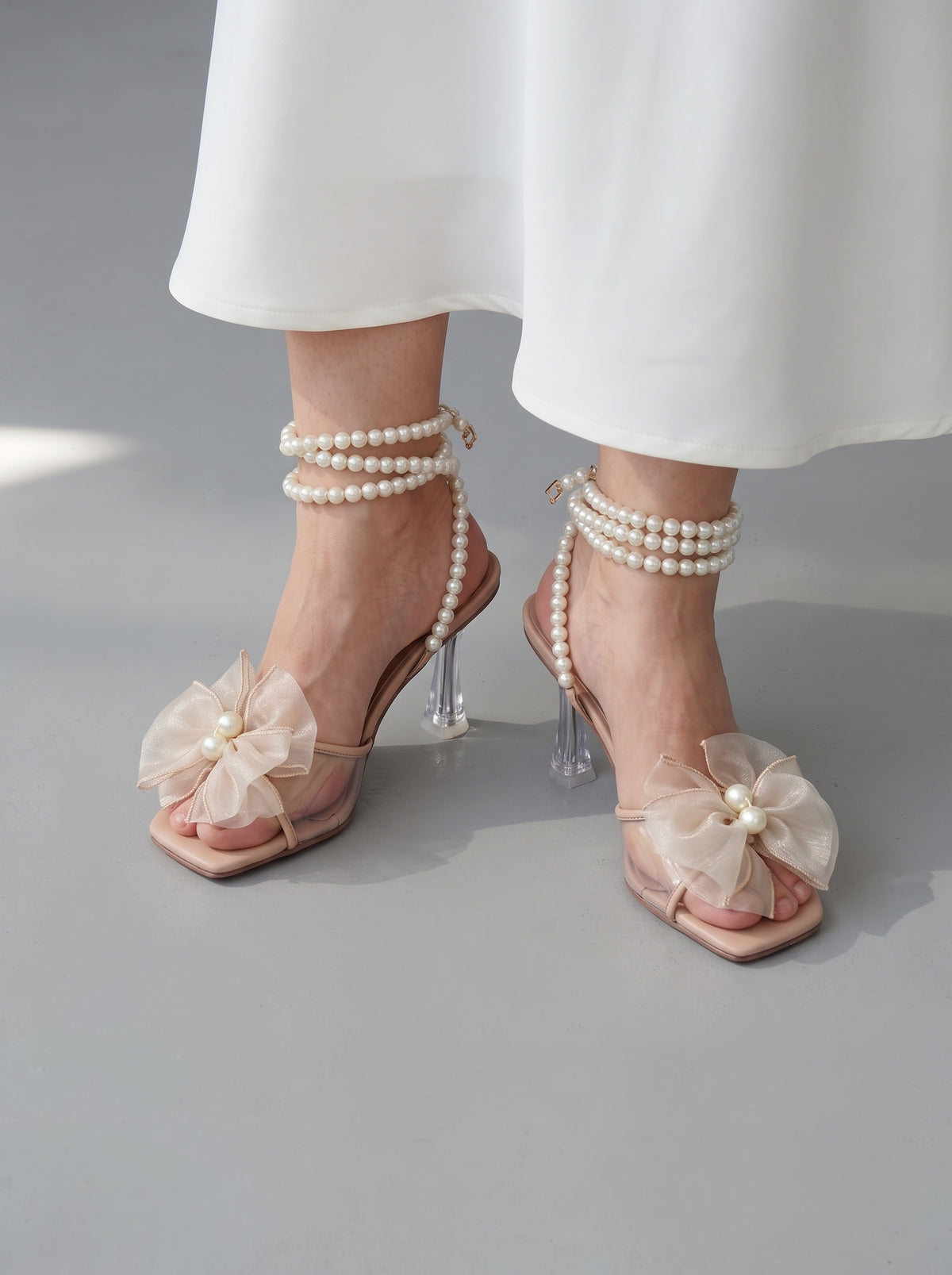 Pearl Bloom heels for women with pearl ankle straps, sheer floral embellishment, open toe and slim transparent-style heel